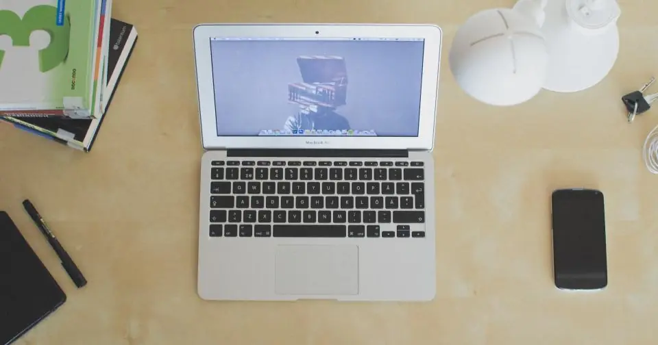 Open laptop on a work desk, seen from above