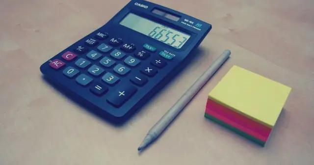 Blue calculator on a desk with a pencil and sticky notes