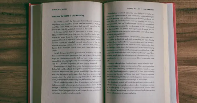 Open book with pages of text on a table