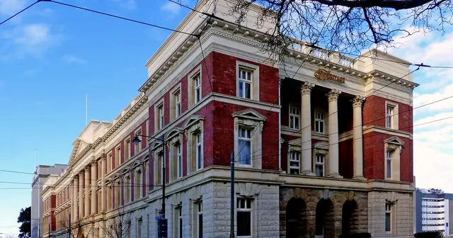 Facade of a historic red-brick government building under a blue sky