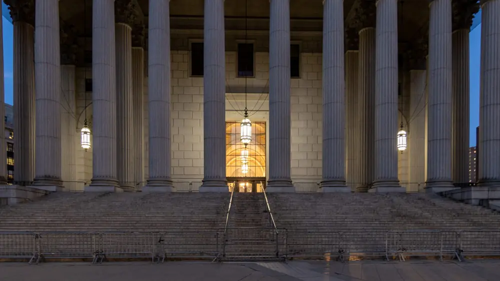 Courthouse colonnade lit at dusk